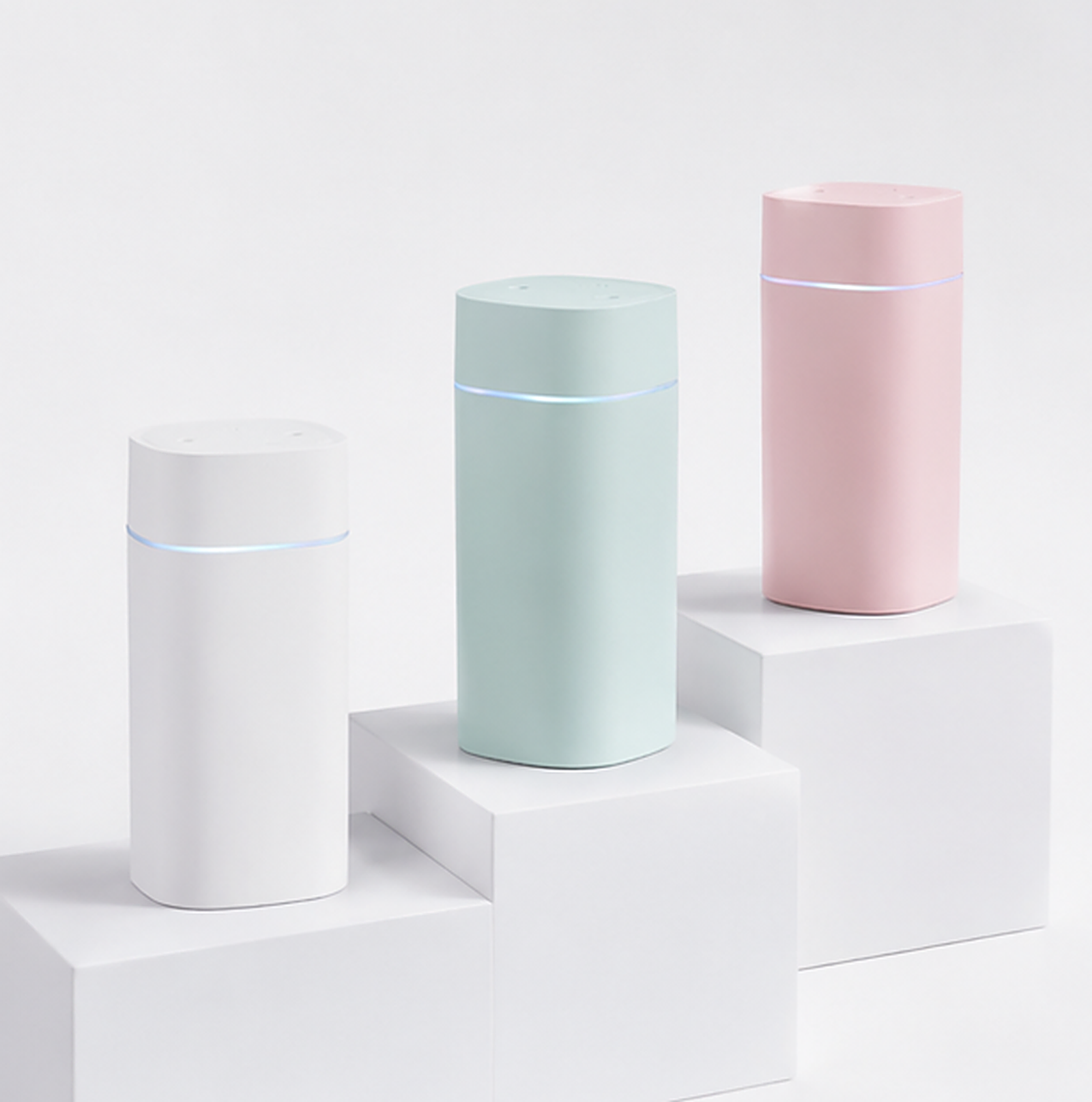 All three colourways of the Amalvi humidifier — White, Green and Pink — side by side.